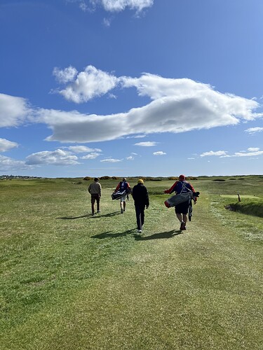 Mitch, Zheng and their caddies.