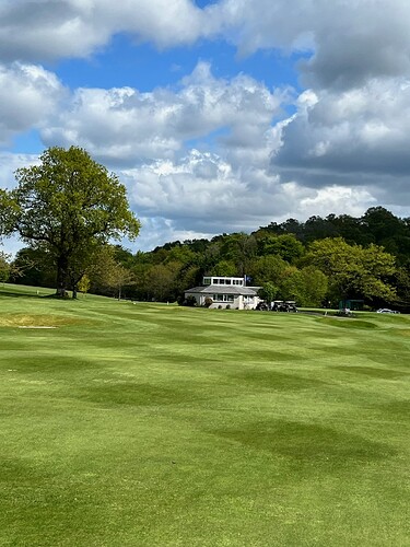 The 18th green with the pro shop just behind it. Slightly downhill, a light wind at our back...pulled out my driver and busted a 297yd drive to just through the green. A nice little chip and putt for my bird.
