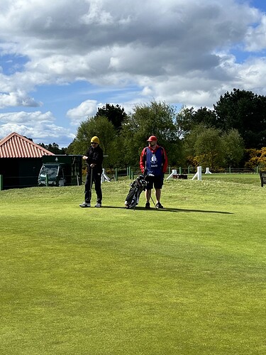 Zheng awaits his turn to hit on #10..