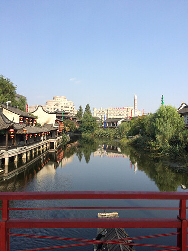 A view of Songcheng from a bridge over a river running through it.