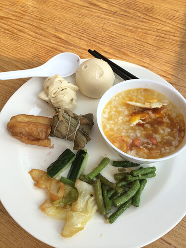 Halfway through my first breakfast in China. Congee, veg, bao, and some fried things. Delicious.