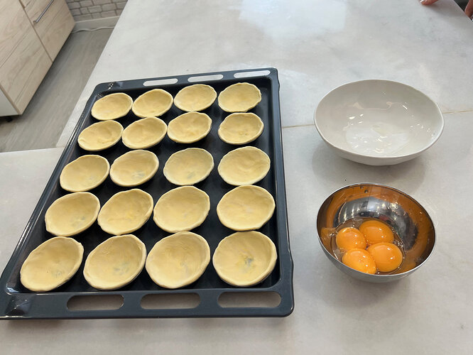 The pastry in the tins, waiting for the custard