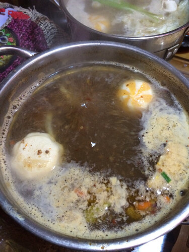 I have white squishy things, orange/white striped squishy things, shrimp, sausages and white/yellow squishy things cooking in my hot pot