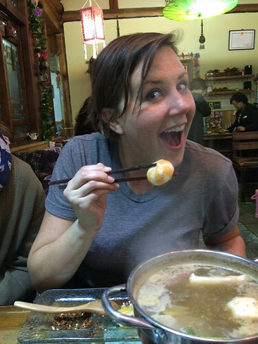 Kendra tries one of the striped orange squishy things. They had some sort of filling….