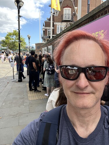 On the queue with the other Groundlings.